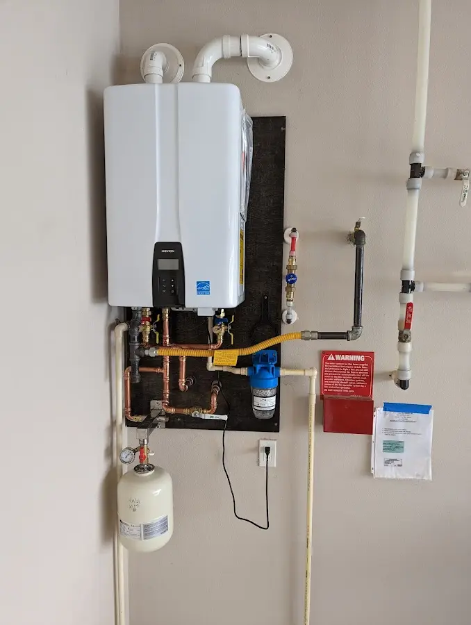 Professional plumber installing copper piping in a Siloam Springs home